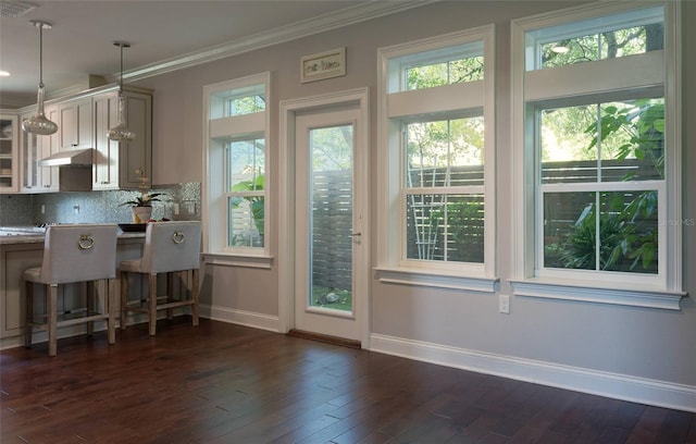 entryway with dark wood-type flooring and crown molding