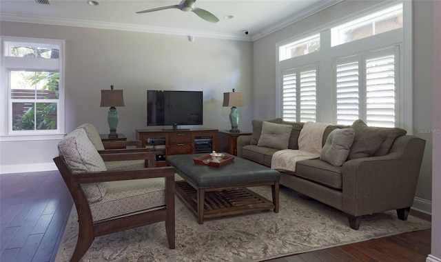 living room featuring plenty of natural light, dark hardwood / wood-style floors, and crown molding