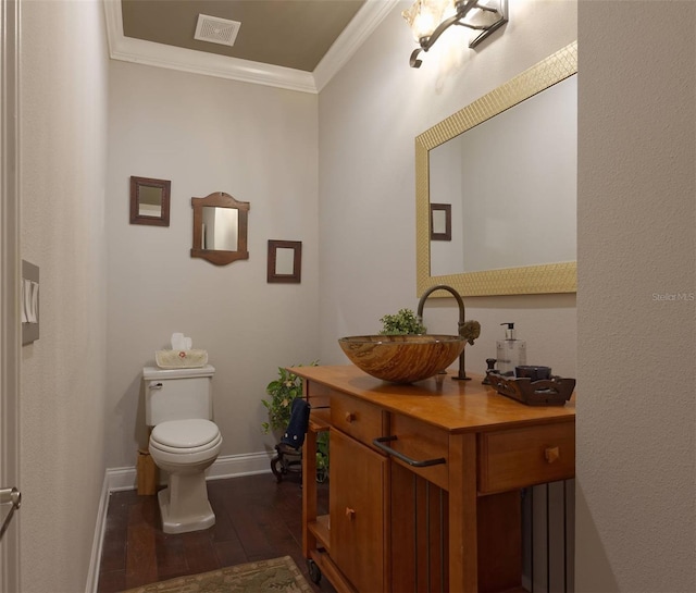 bathroom with crown molding, vanity, toilet, and hardwood / wood-style flooring