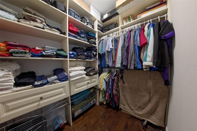 spacious closet with dark hardwood / wood-style flooring