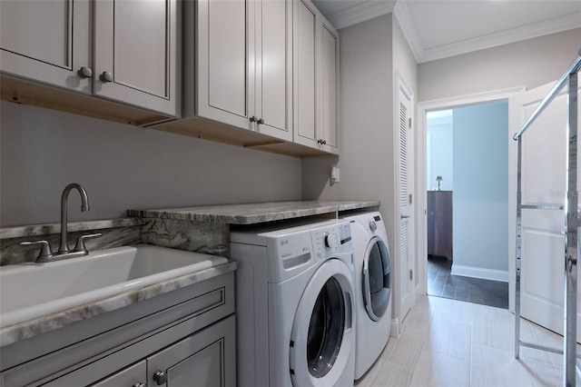 clothes washing area featuring independent washer and dryer, light tile patterned floors, cabinets, ornamental molding, and sink