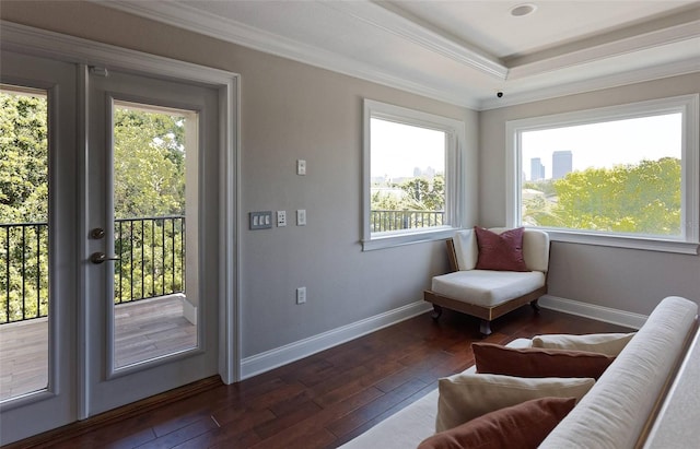 living area featuring french doors, crown molding, dark wood-type flooring, and a wealth of natural light