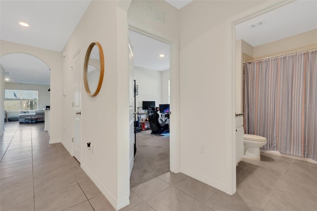 hall with light tile patterned floors