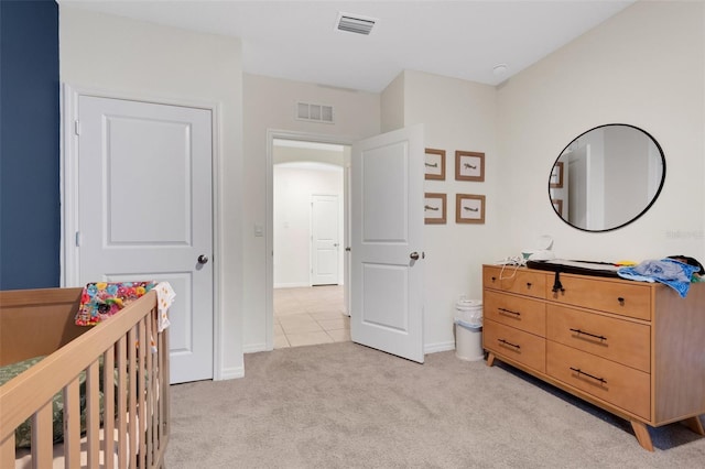 carpeted bedroom with a nursery area