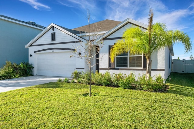 view of front of property featuring a front yard and a garage