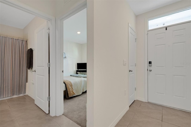 foyer entrance with light colored carpet