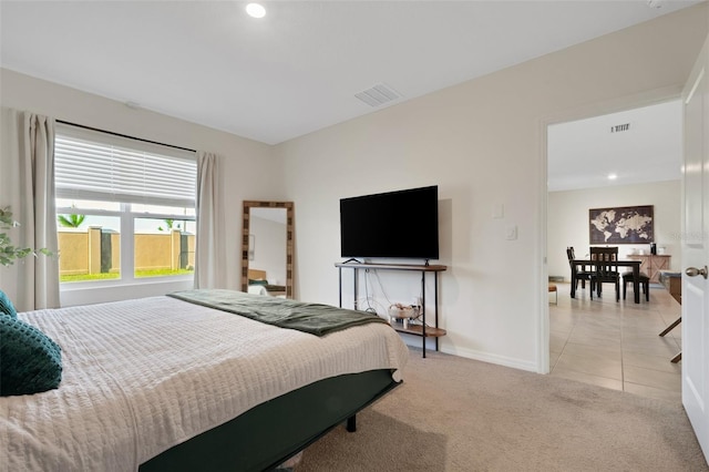 bedroom featuring light carpet