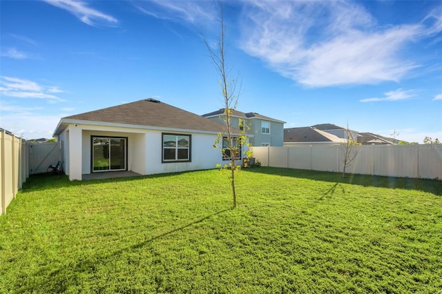 back of house featuring a lawn