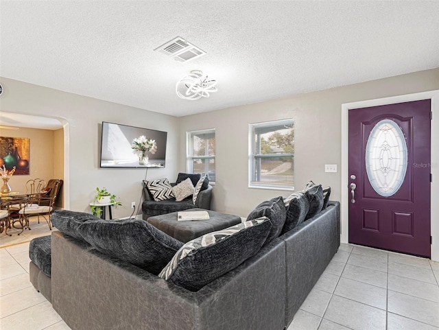 living room with light tile patterned floors and a textured ceiling