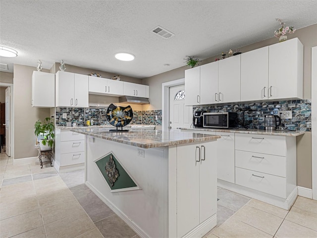 kitchen featuring white cabinets and a kitchen island