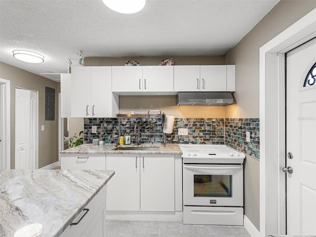 kitchen featuring white cabinets, under cabinet range hood, white electric range oven, decorative backsplash, and a sink