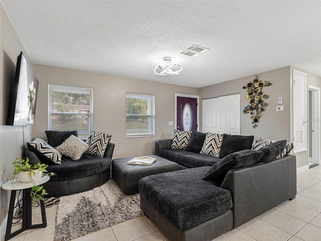 tiled living room featuring a textured ceiling and plenty of natural light