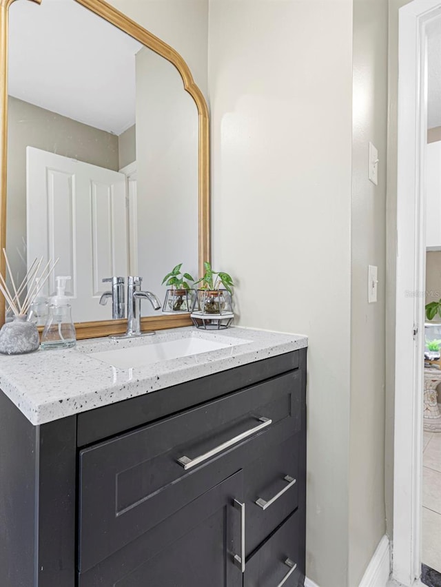 bathroom with baseboards and vanity