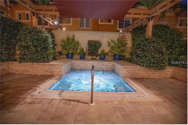 view of pool with an in ground hot tub and a patio