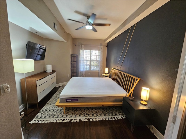 bedroom with ceiling fan and dark hardwood / wood-style flooring