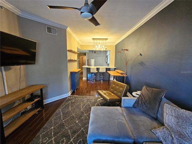 living room featuring ceiling fan, dark hardwood / wood-style flooring, and crown molding