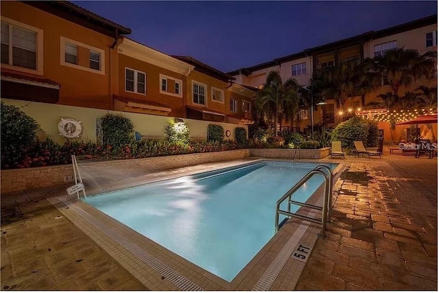 view of swimming pool featuring a patio area