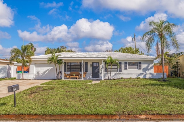 ranch-style home with a front lawn and a garage