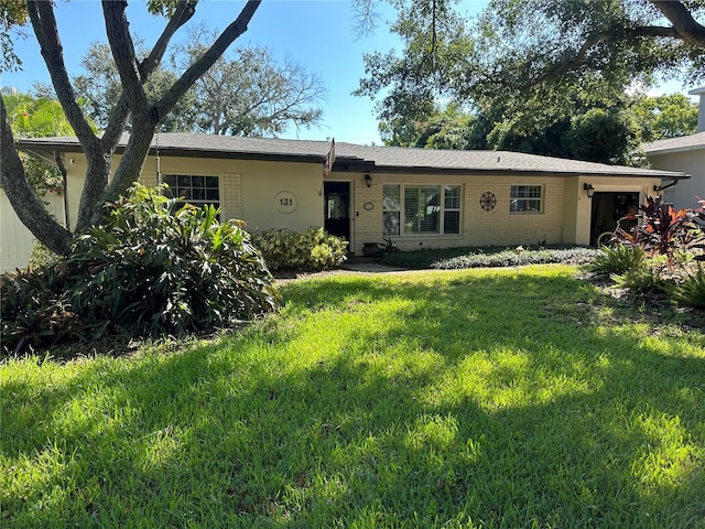 single story home with a front yard and a garage