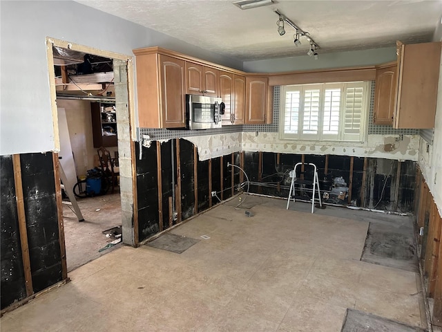 kitchen featuring rail lighting