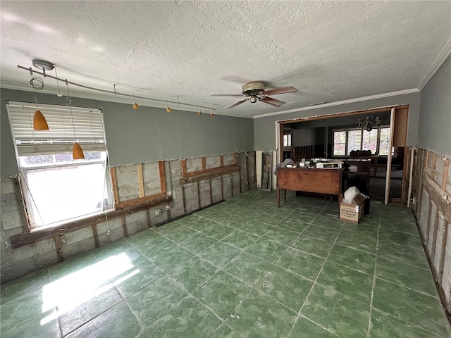 interior space with ornamental molding, a textured ceiling, and ceiling fan