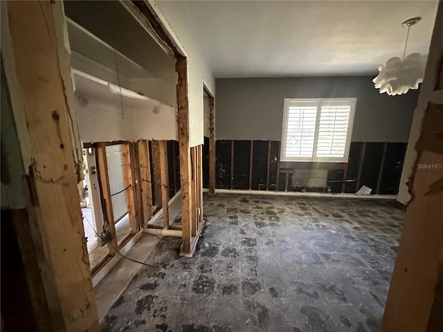 miscellaneous room featuring an inviting chandelier