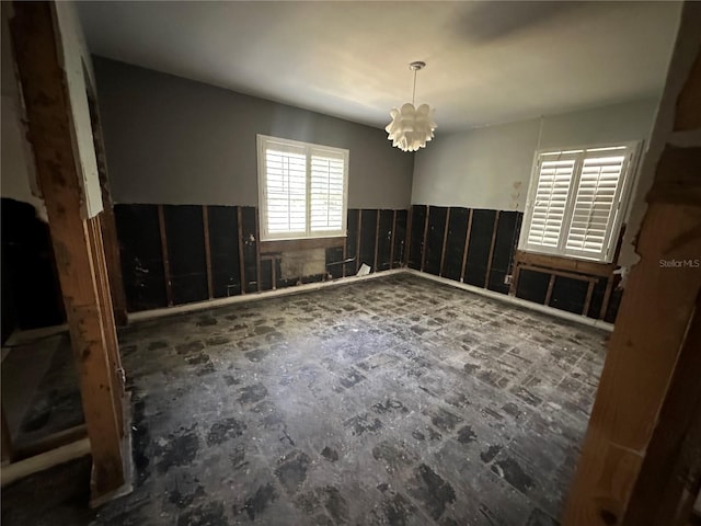 empty room featuring a chandelier