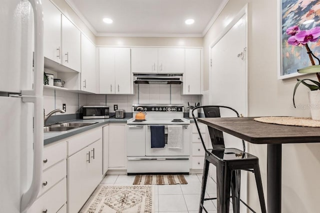 kitchen featuring a kitchen breakfast bar, white appliances, white cabinetry, and sink