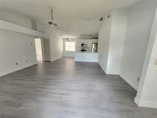 unfurnished living room featuring light hardwood / wood-style flooring and ceiling fan