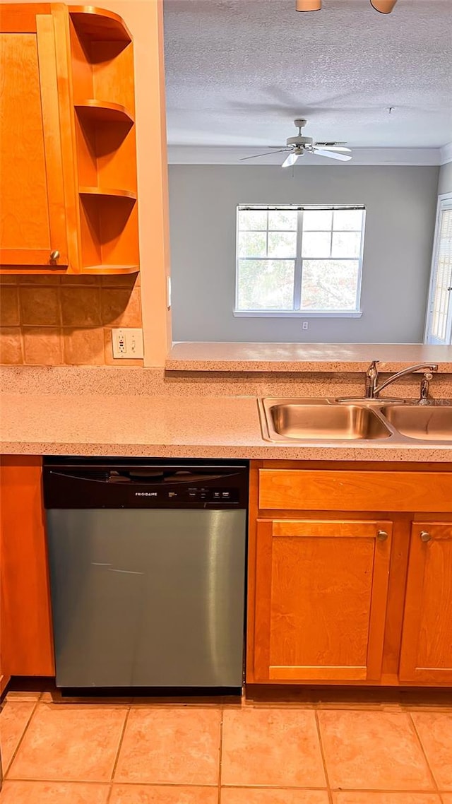 kitchen featuring sink, dishwasher, a textured ceiling, ceiling fan, and light tile patterned floors