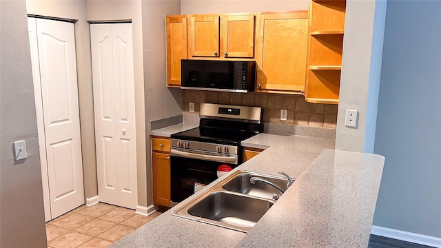 kitchen featuring stainless steel range with electric stovetop, decorative backsplash, sink, and light tile patterned floors