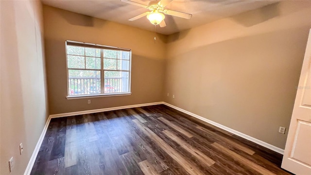 empty room featuring dark wood-type flooring and ceiling fan