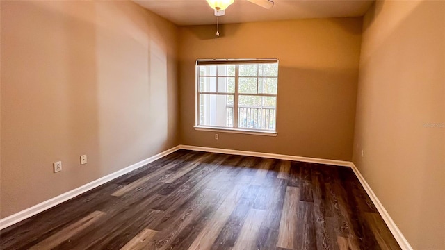 spare room featuring dark wood-type flooring and ceiling fan