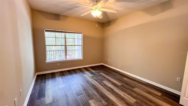 empty room featuring ceiling fan and dark hardwood / wood-style flooring