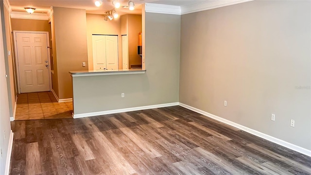 spare room with crown molding and dark hardwood / wood-style flooring