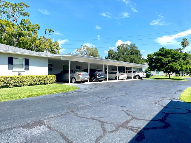 view of vehicle parking featuring a yard