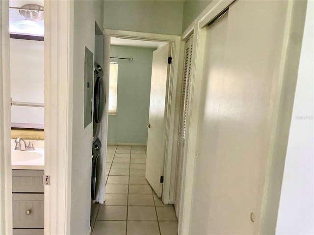 corridor with light tile patterned flooring and sink