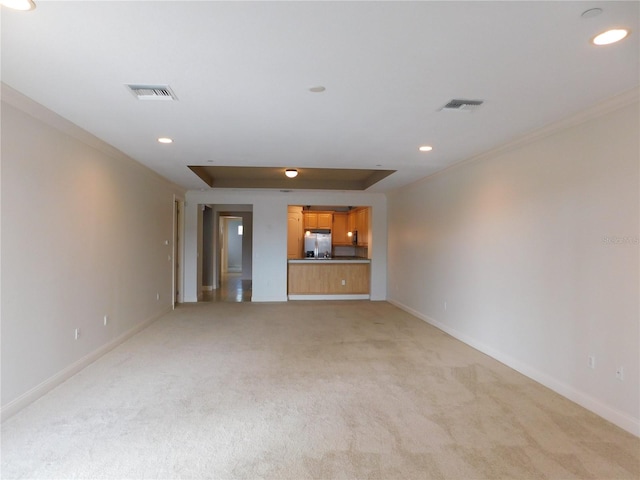 unfurnished living room featuring light carpet and ornamental molding