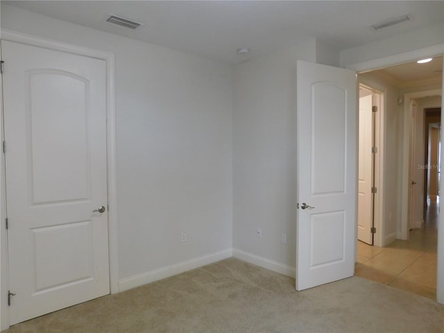 empty room featuring light colored carpet