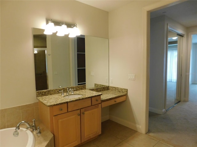 bathroom with vanity, tile patterned floors, and a relaxing tiled tub