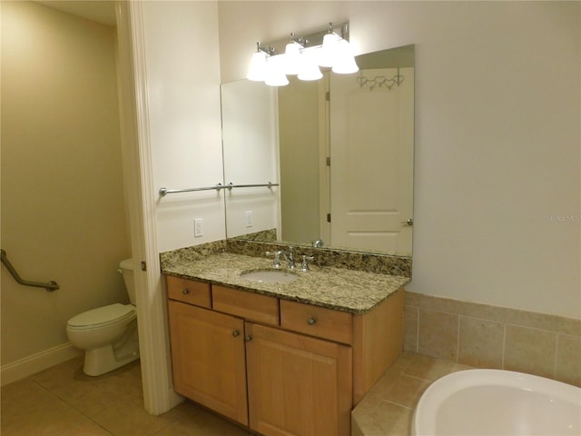 bathroom with vanity, tile patterned flooring, toilet, and a washtub