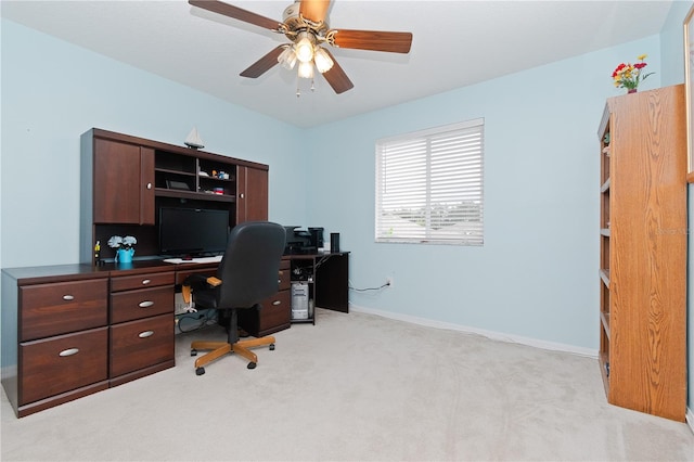 carpeted office featuring ceiling fan