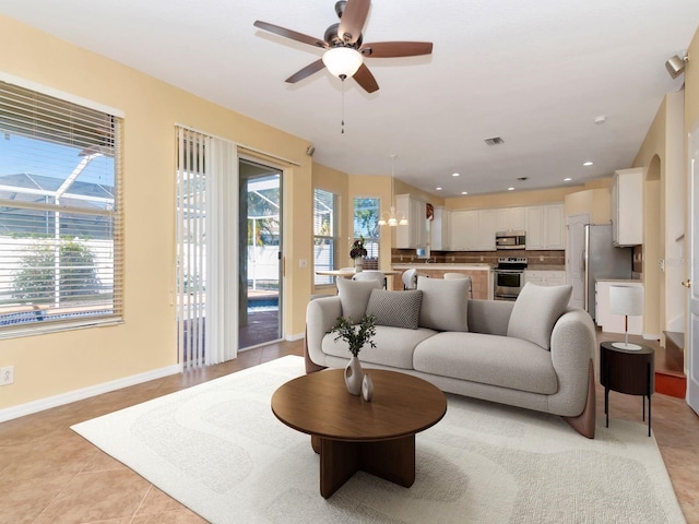 living room with light tile patterned flooring and ceiling fan