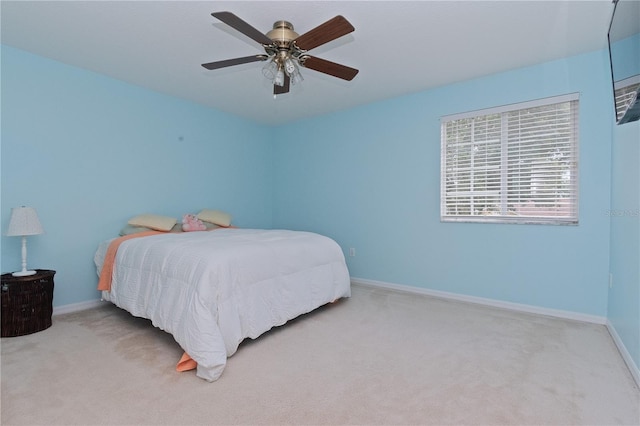 bedroom featuring ceiling fan and light carpet