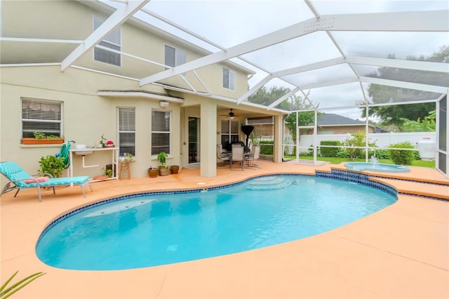 view of swimming pool featuring an in ground hot tub, a lanai, and a patio area