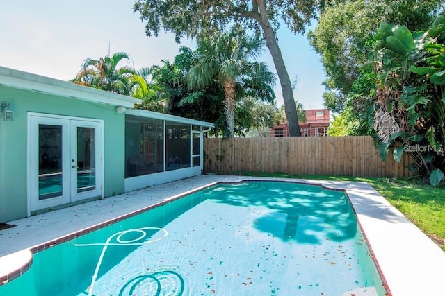 view of pool with a sunroom and a patio area