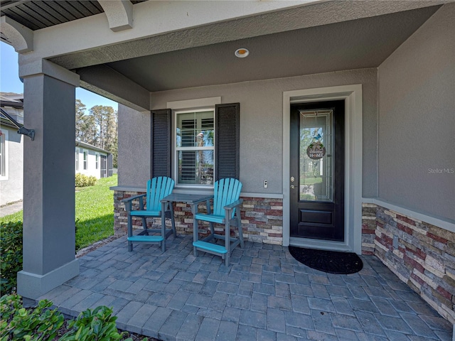 entrance to property featuring a porch