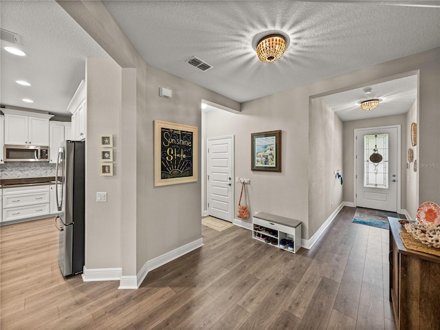 entrance foyer featuring hardwood / wood-style floors and a textured ceiling