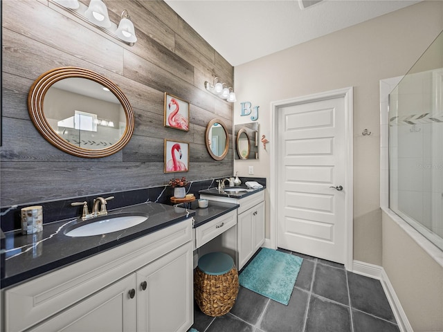 bathroom featuring vanity, a shower, wood walls, and tile patterned floors