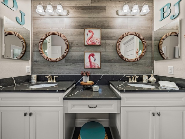 bathroom featuring vanity and tasteful backsplash